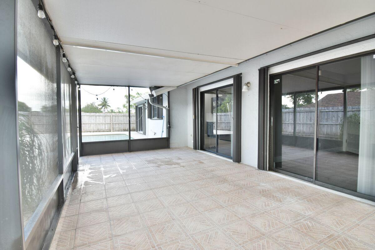 9425 Longmeadow Circle Boynton Beach, FL 33436 - Photo 29 of 34 a view of an empty room with glass door