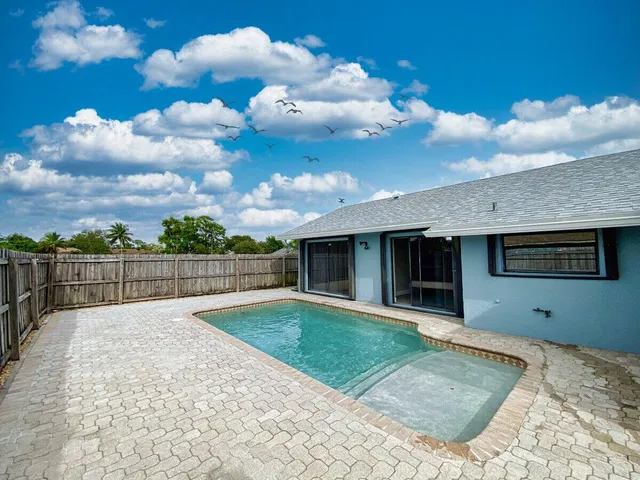 a view of a backyard of the house
