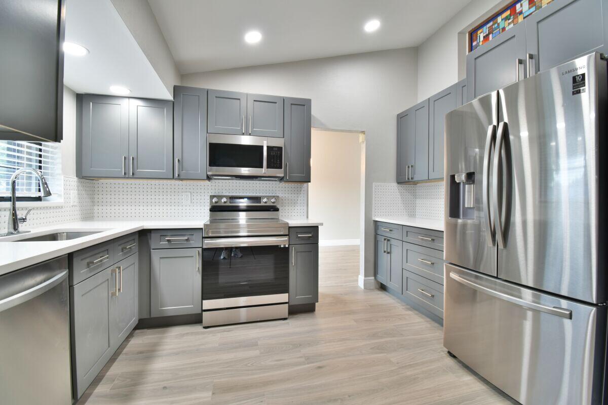 9425 Longmeadow Circle Boynton Beach, FL 33436 - Photo 4 of 34 a kitchen with a refrigerator stove and microwave