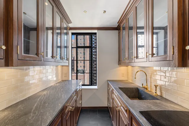 a living room with furniture a fireplace and a dining table with wooden floor