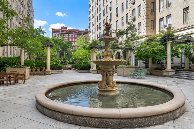 a view of a fountain with sitting area