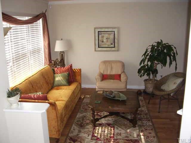 9814 Layla Avenue Raleigh, NC 27617 - Photo 2 of 7 a living room with furniture and a lamp
