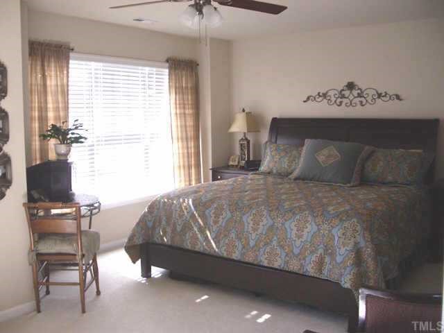 9814 Layla Avenue Raleigh, NC 27617 - Photo 7 of 7 a bedroom with a bed and furniture