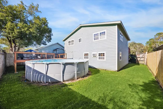 a view of an house with backyard and a tree