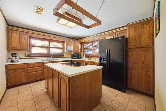 a kitchen with refrigerator cabinets and furniture