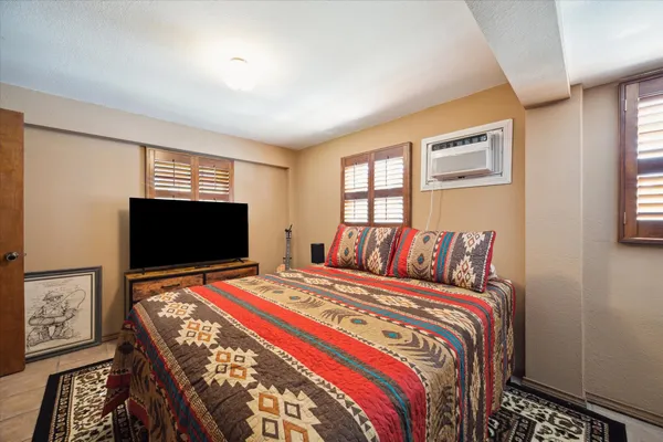 a bedroom with a bed and a flat screen tv