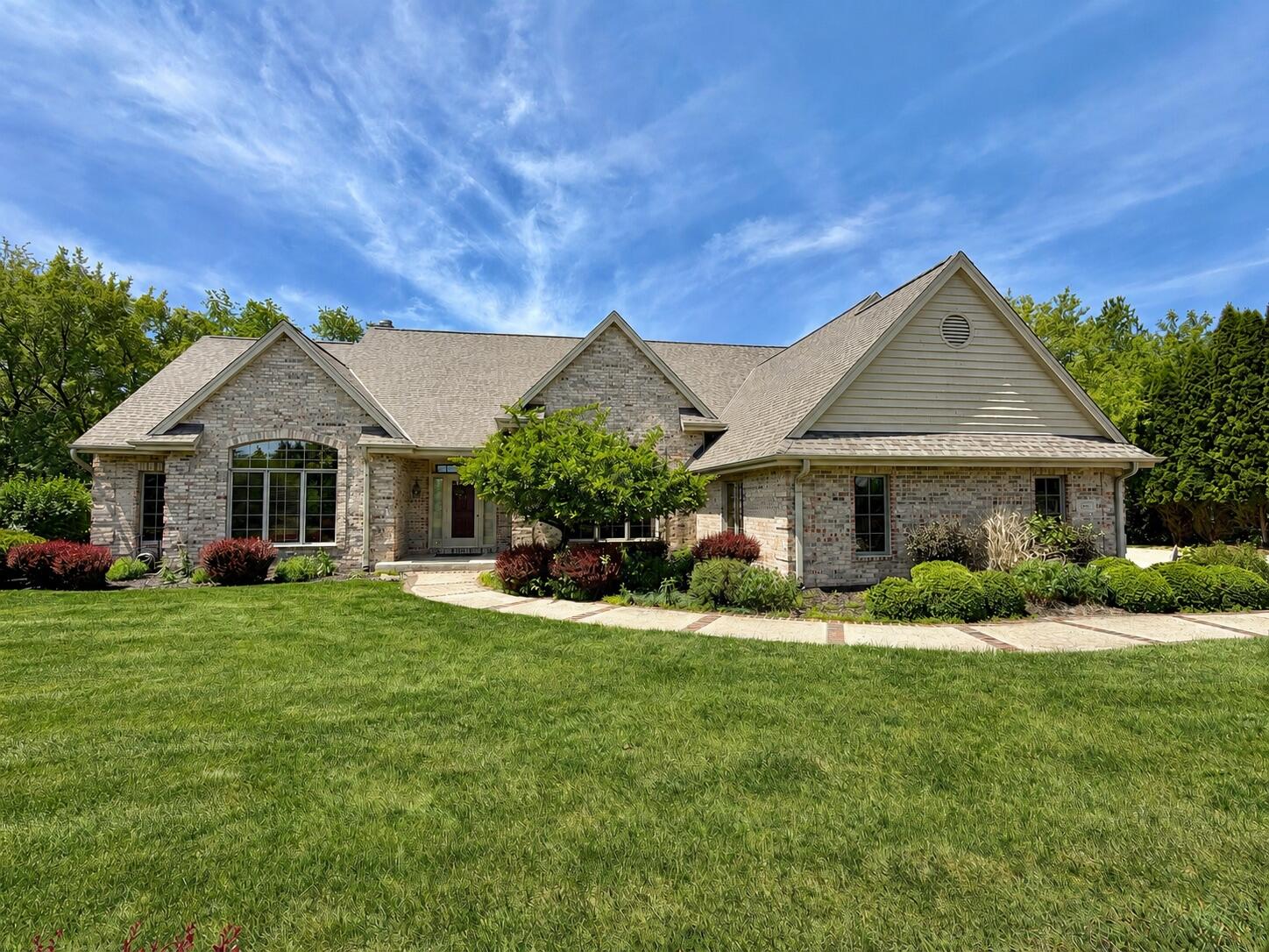 Original owner offers this Stunning custom brick ranch set on a beautifully landscaped 3-acre estate-sized lot in sought-after Ridgefield Bay. A dramatic front elevation, soaring rooflines, mature landscaping, and exceptional curb appeal create a memorable first impression. Nestled among mature trees, this executive home offers privacy, quality craftsmanship, and timeless architectural design.