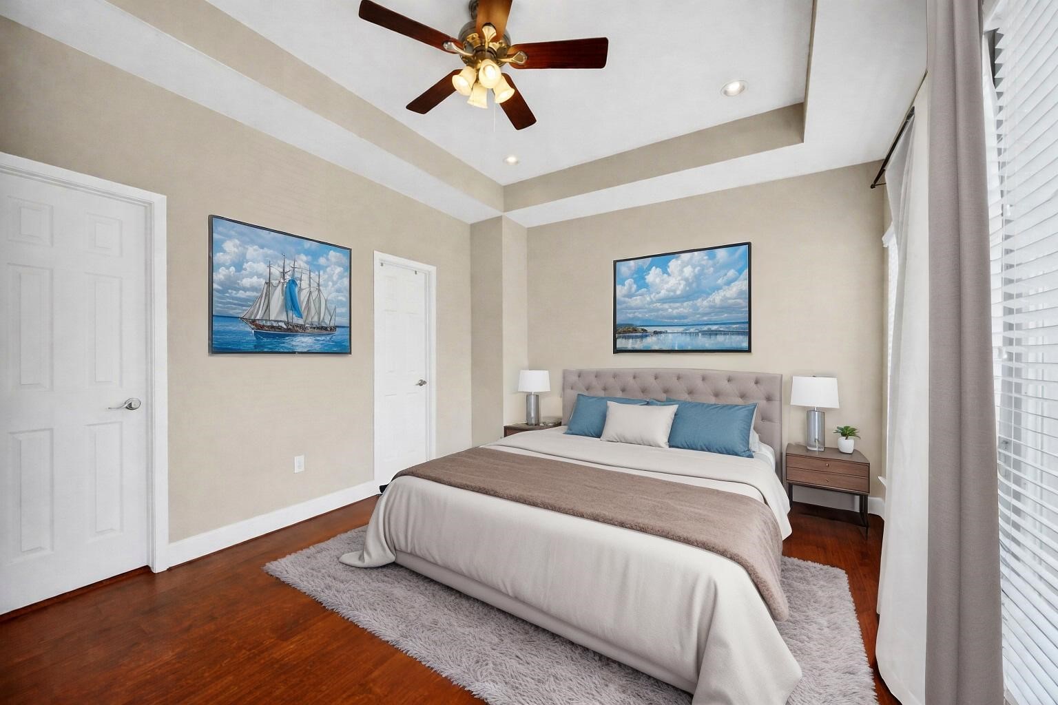 5206 Petty Street Houston, TX 77007 - Photo 14 of 26 a bedroom with a large bed and a chandelier