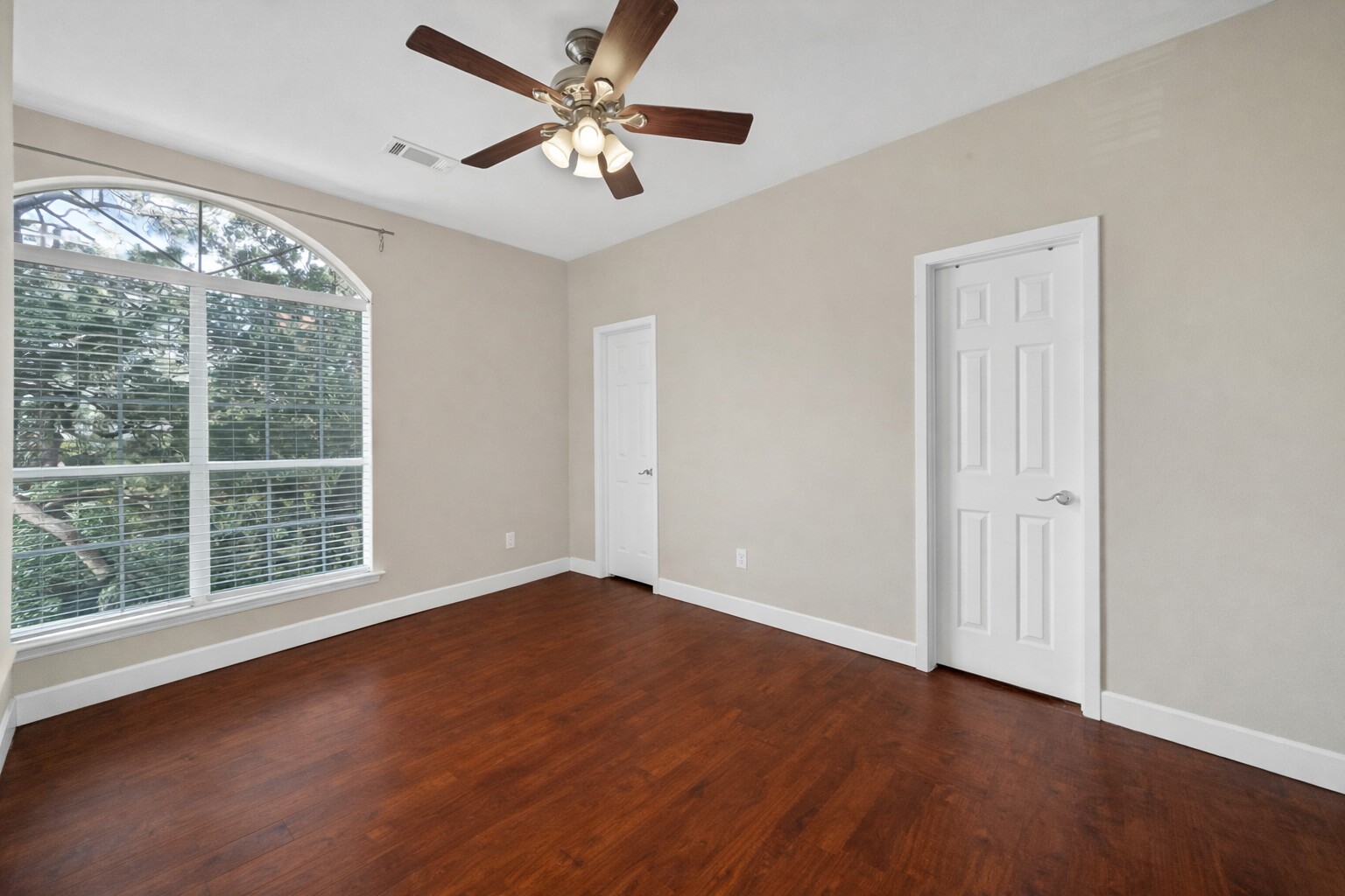 5206 Petty Street Houston, TX 77007 - Photo 18 of 26 an empty room with wooden floor fan and windows
