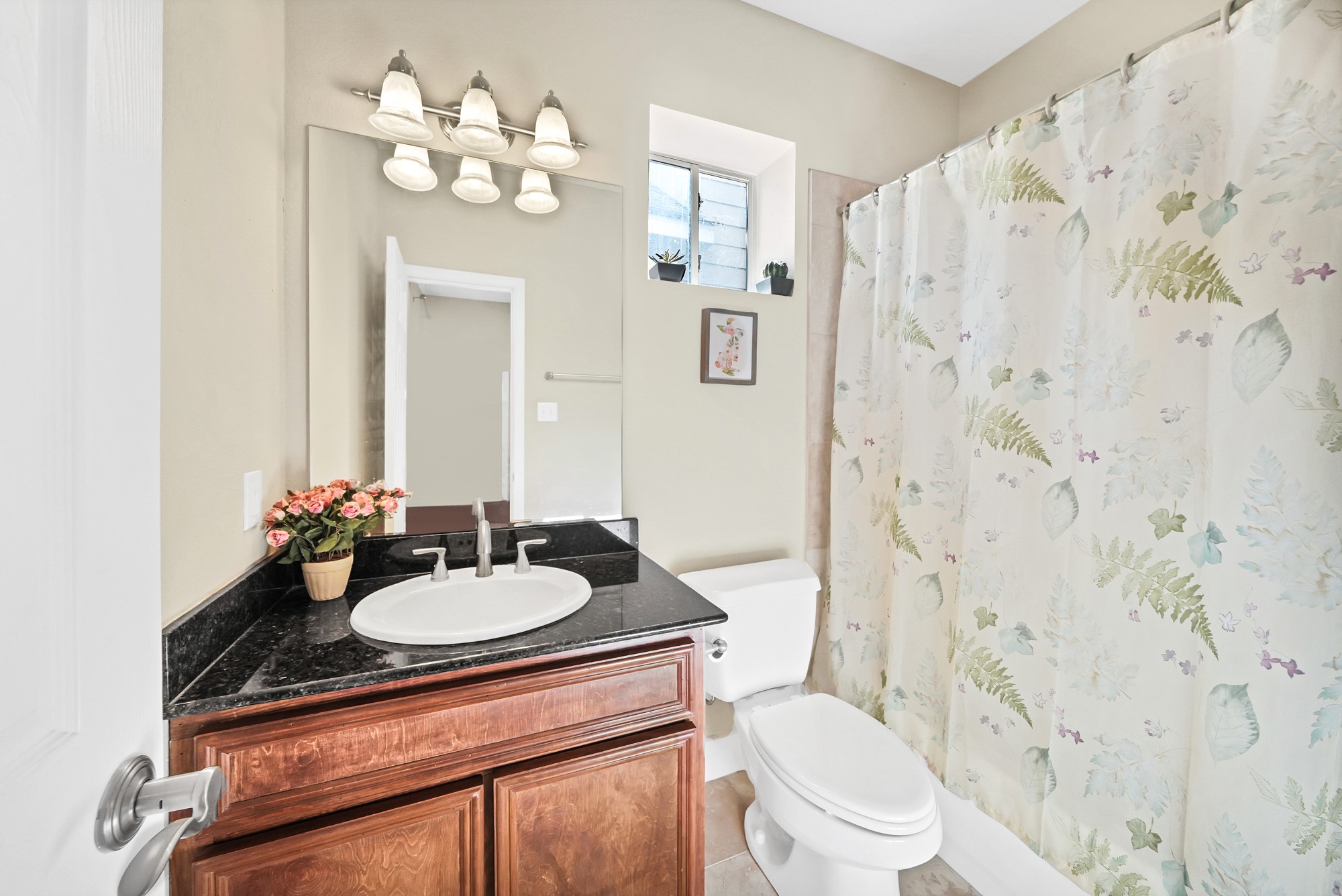 5206 Petty Street Houston, TX 77007 - Photo 6 of 26 a bathroom with a sink a toilet and a mirror