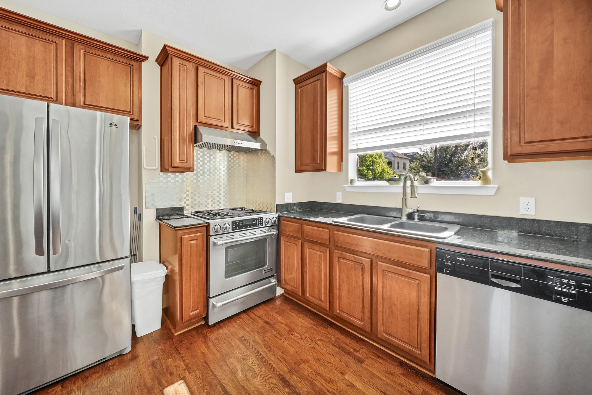 5206 Petty Street Houston, TX 77007 - Photo 8 of 26 a kitchen with stainless steel appliances granite countertop a sink a stove and a refrigerator