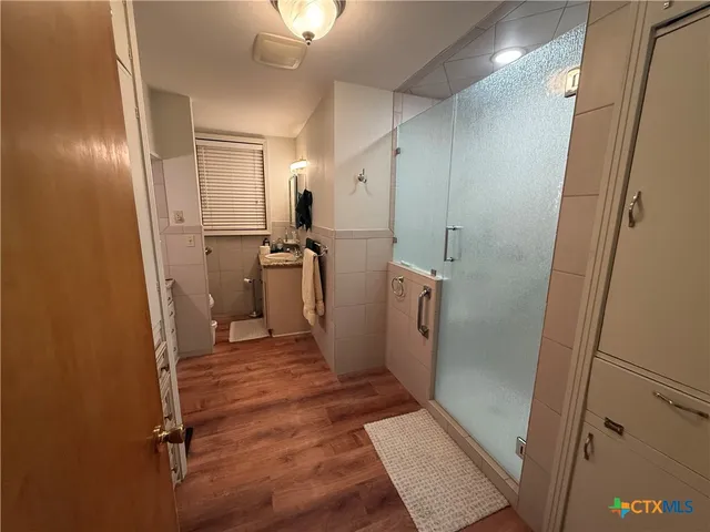 a view of a hallway with a refrigerator