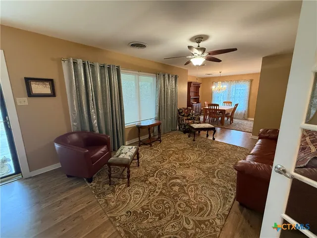 a living room with furniture and a chandelier