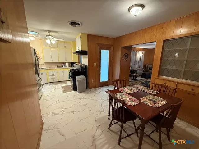 a large kitchen with a table and chairs in it