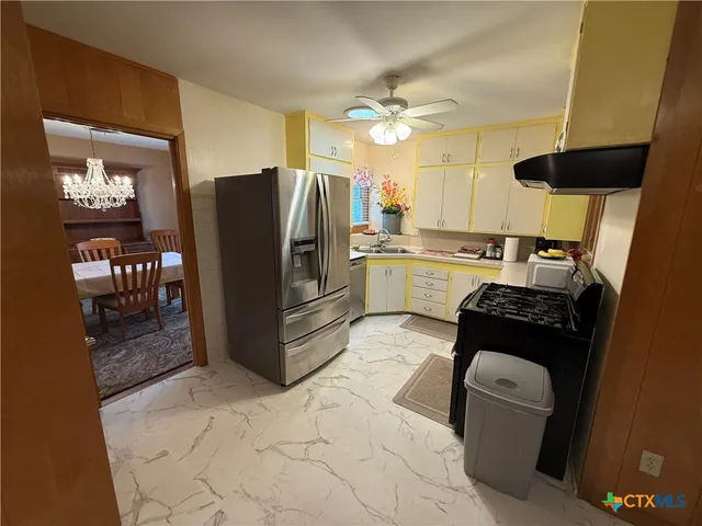 a kitchen with a refrigerator and a stove