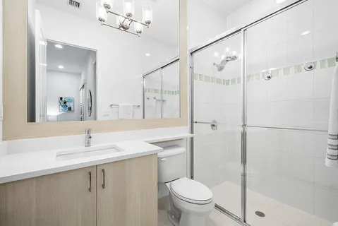 a bathroom with a sink toilet and shower