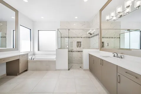 a bathroom with a tub sink shower and mirror