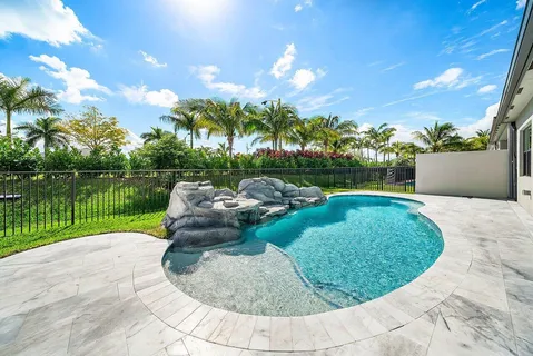 a view of a swimming pool with a yard