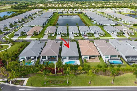 an aerial view of multiple houses with a swimming pool