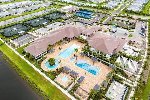 an aerial view of a house a yard and swimming pool