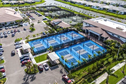 an aerial view of a house with a garden and lake view