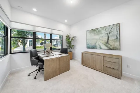 a view of workspace with wooden floor and windows