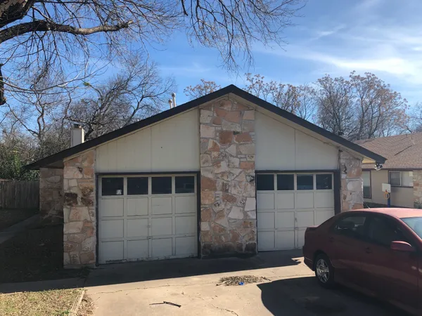 a front view of a house with parking