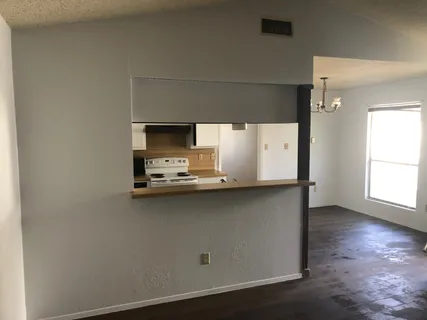a kitchen with a sink a microwave and wooden floor