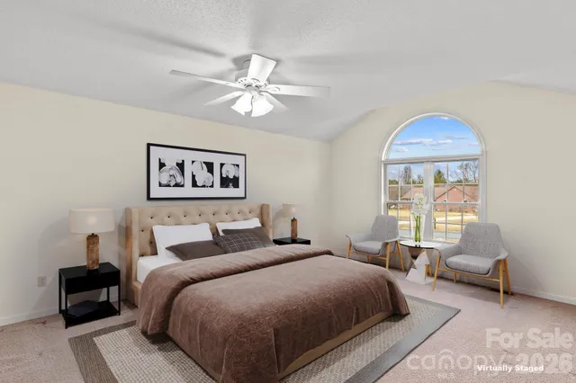 an empty room with a window and ceiling fan