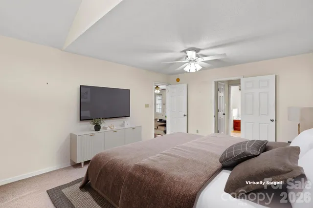 an empty room with closet and a ceiling fan