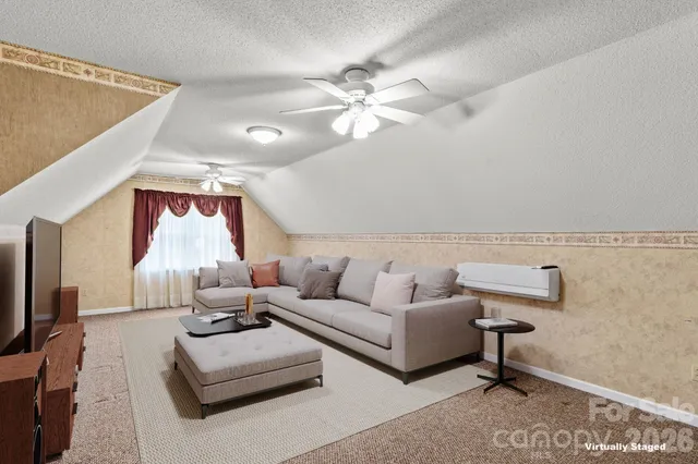 en empty room with windows and ceiling fan