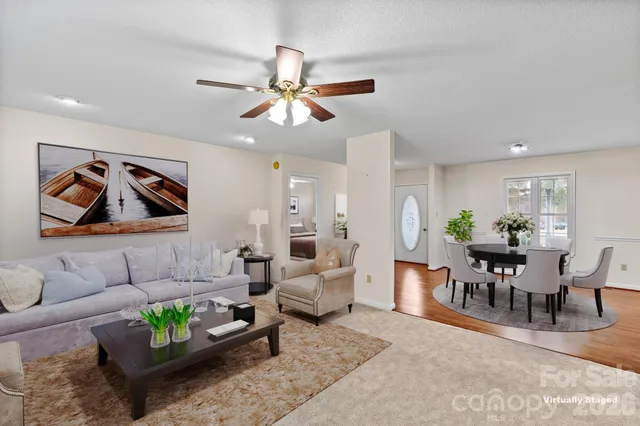 a living room with furniture and a dining area