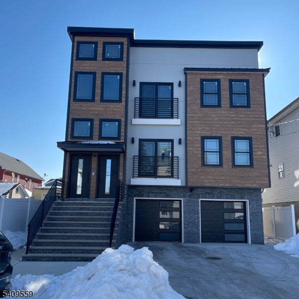 1297 Avy Street Hillside, NJ 07205 - Photo 1 of 15 a front view of a house with entryway and a yard