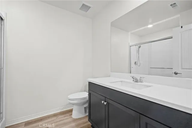 a bathroom with a sink a toilet and mirror