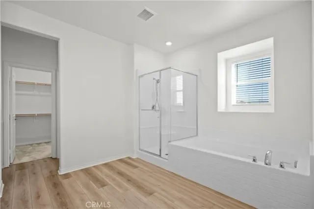 a bathroom with a bathtub and a shower