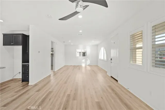 a view of empty room with wooden floor and window