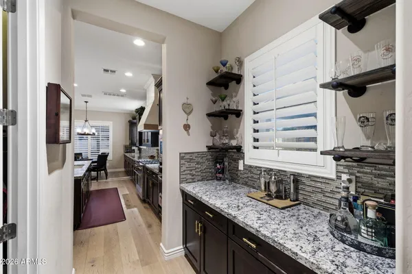 a kitchen with granite countertop a sink a counter top space appliances and cabinets