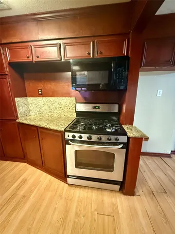a stove top oven sitting inside of a kitchen