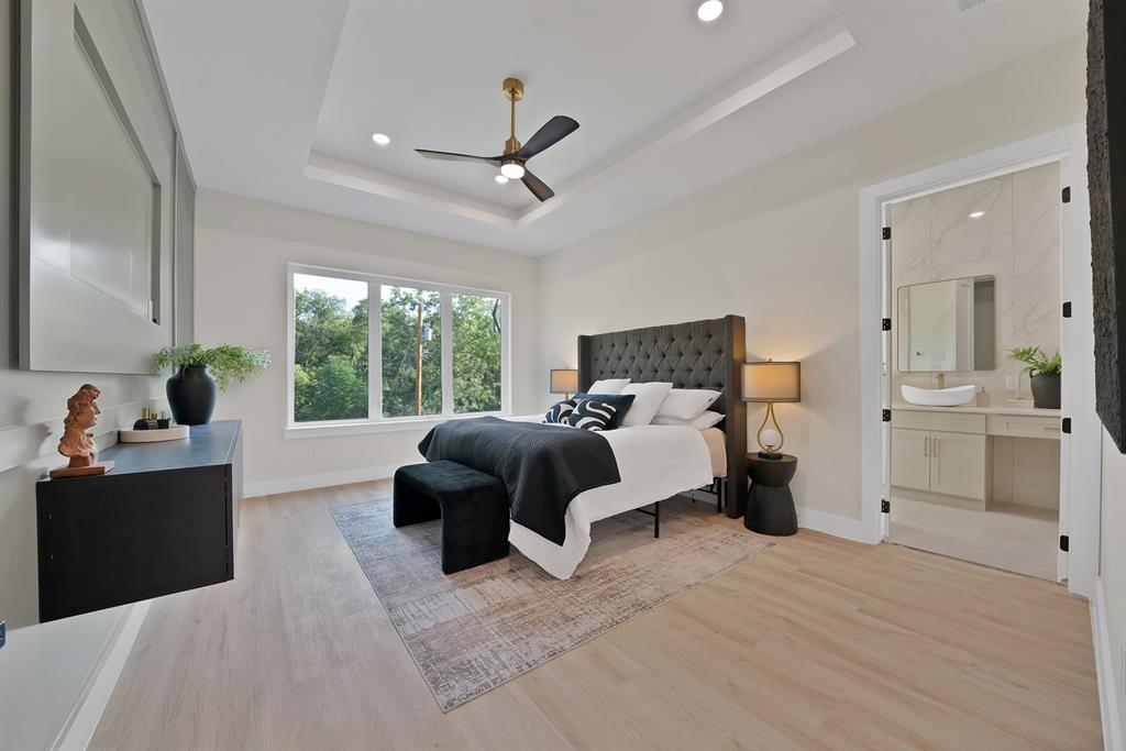 1415 Fayette Street Dallas, TX 75203 - Photo 24 of 40 Tray ceiling with recessed lighting, ceiling fan, and large windows