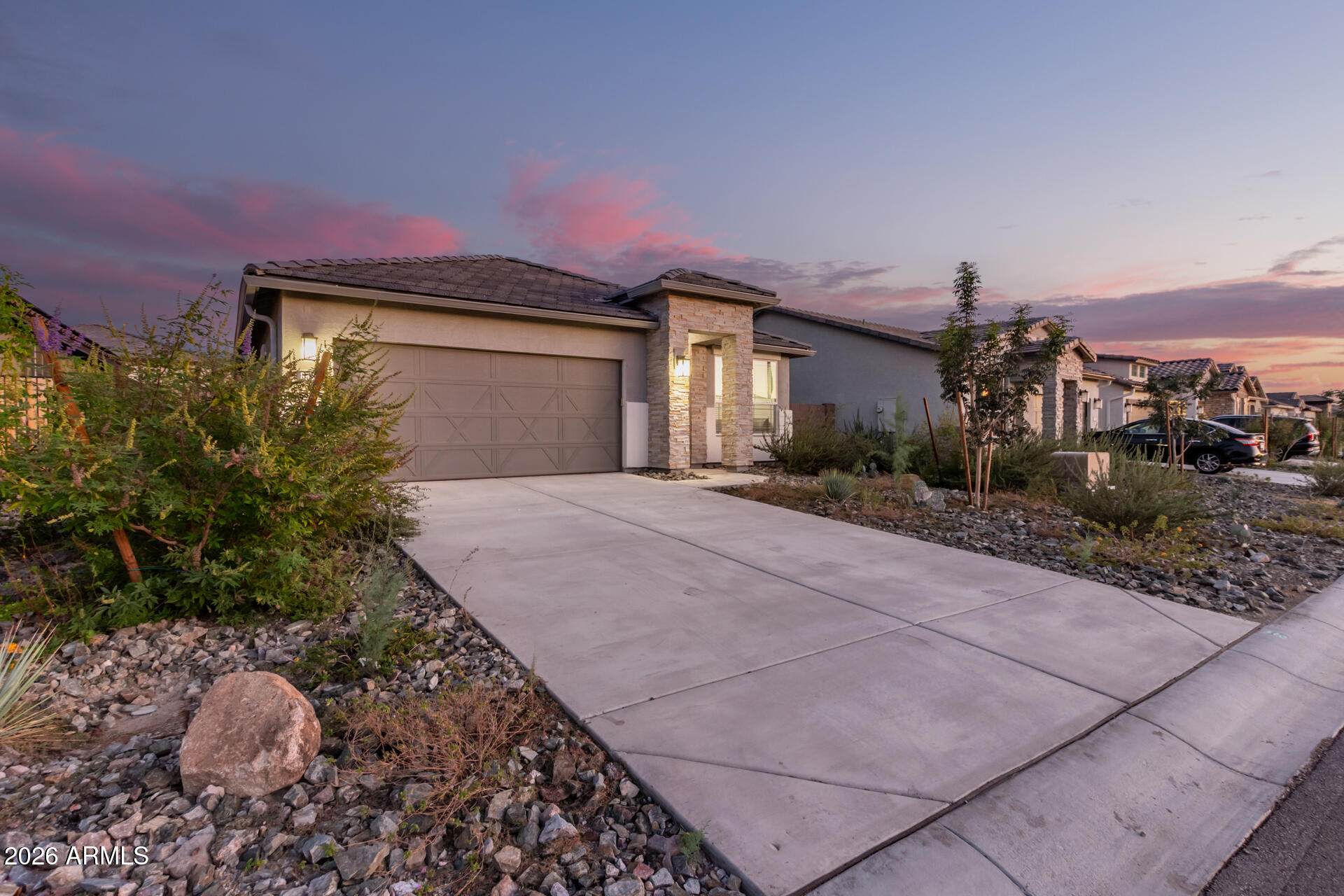 8835 South 166th Avenue Goodyear, AZ 85338 - Photo 14 of 23 a front view of a house with a yard and garage
