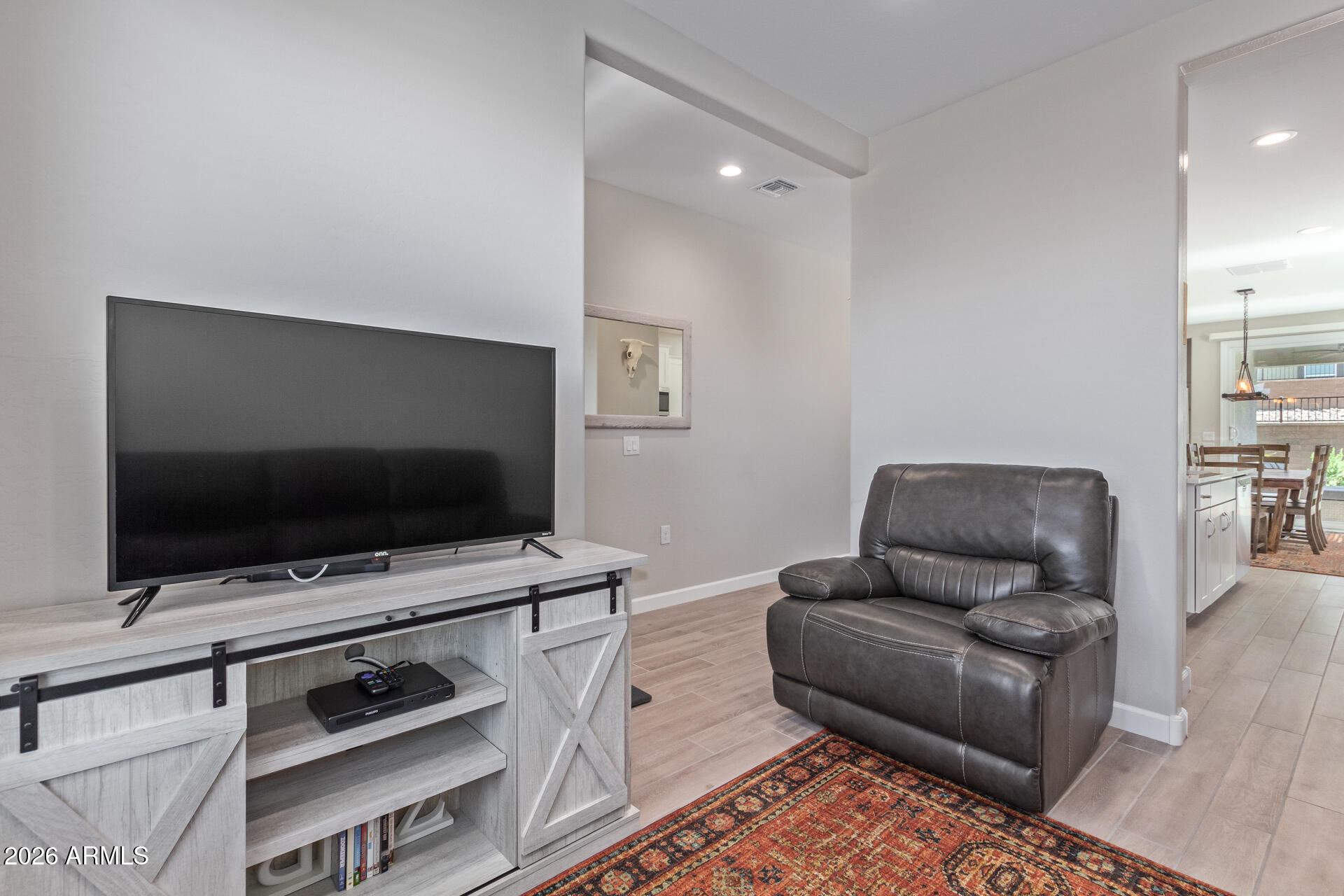 8835 South 166th Avenue Goodyear, AZ 85338 - Photo 17 of 23 a living room with furniture and a flat screen tv
