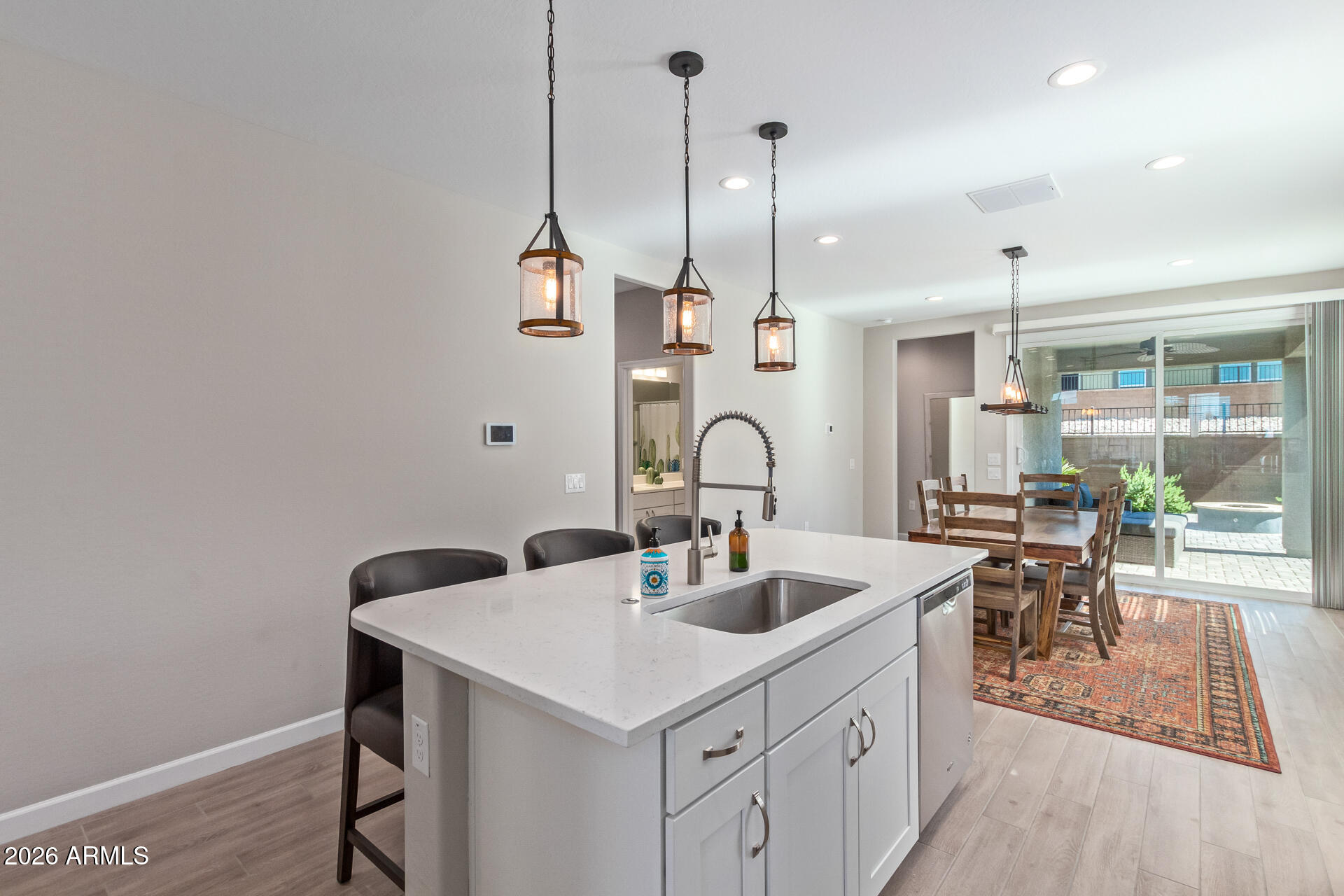 8835 South 166th Avenue Goodyear, AZ 85338 - Photo 18 of 23 a kitchen with sink cabinets and dining table