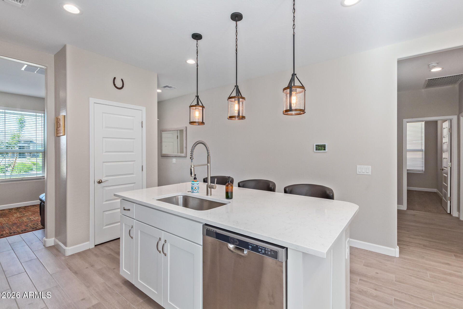 8835 South 166th Avenue Goodyear, AZ 85338 - Photo 20 of 23 a kitchen with stainless steel appliances and wooden floor