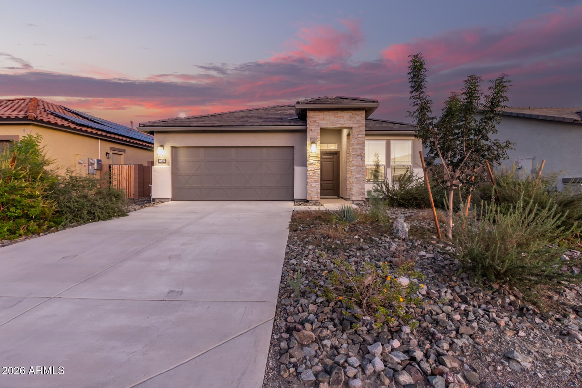 8835 South 166th Avenue Goodyear, AZ 85338 - Photo 23 of 23 a front view of a house with a yard and garage