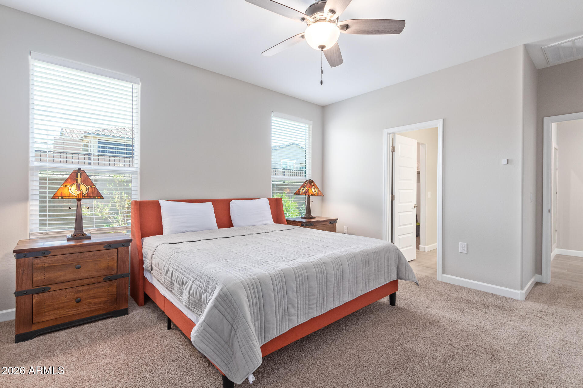 8835 South 166th Avenue Goodyear, AZ 85338 - Photo 4 of 23 a bedroom with a bed and a chandelier
