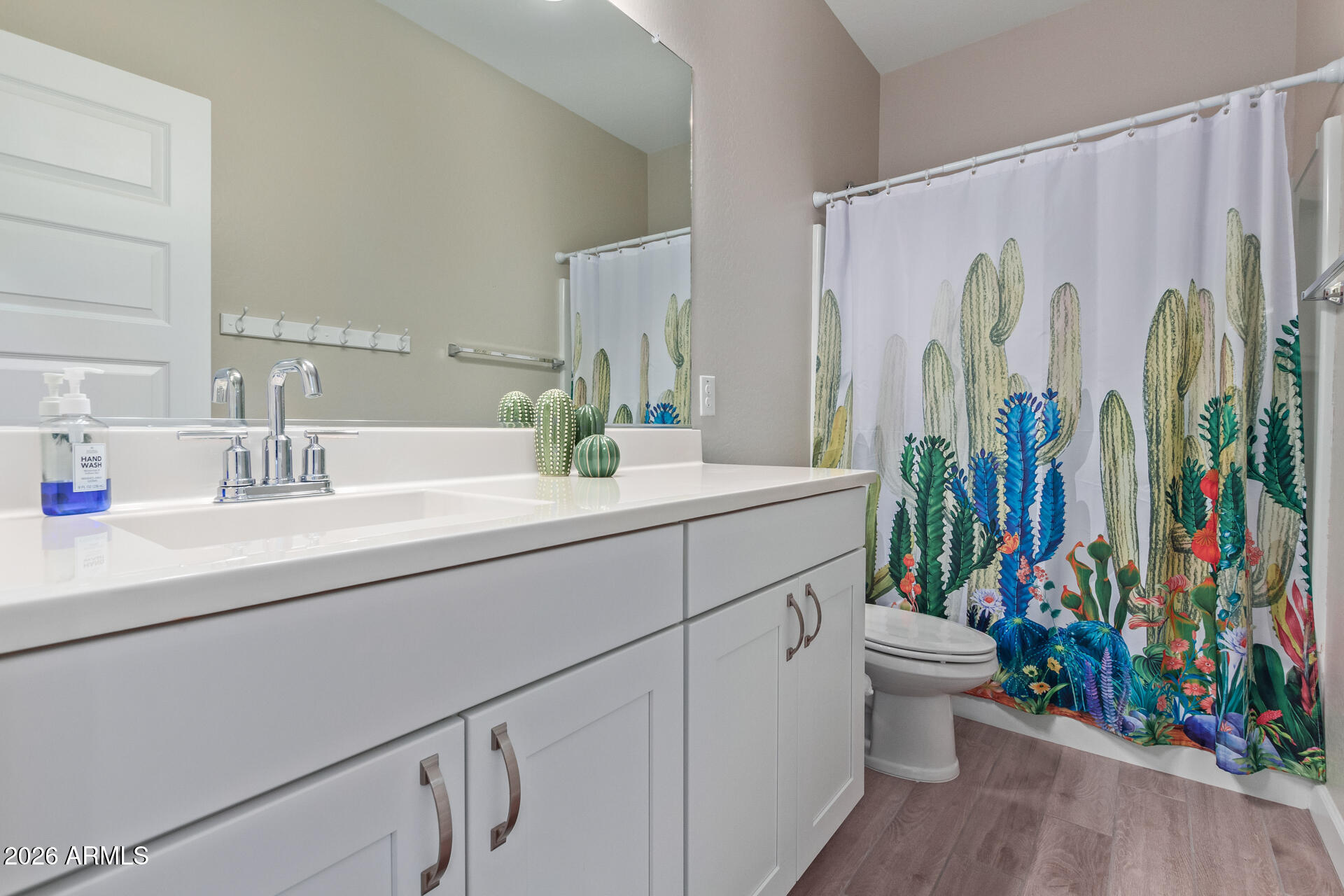 8835 South 166th Avenue Goodyear, AZ 85338 - Photo 7 of 23 a bathroom with a sink a toilet and a shower curtain