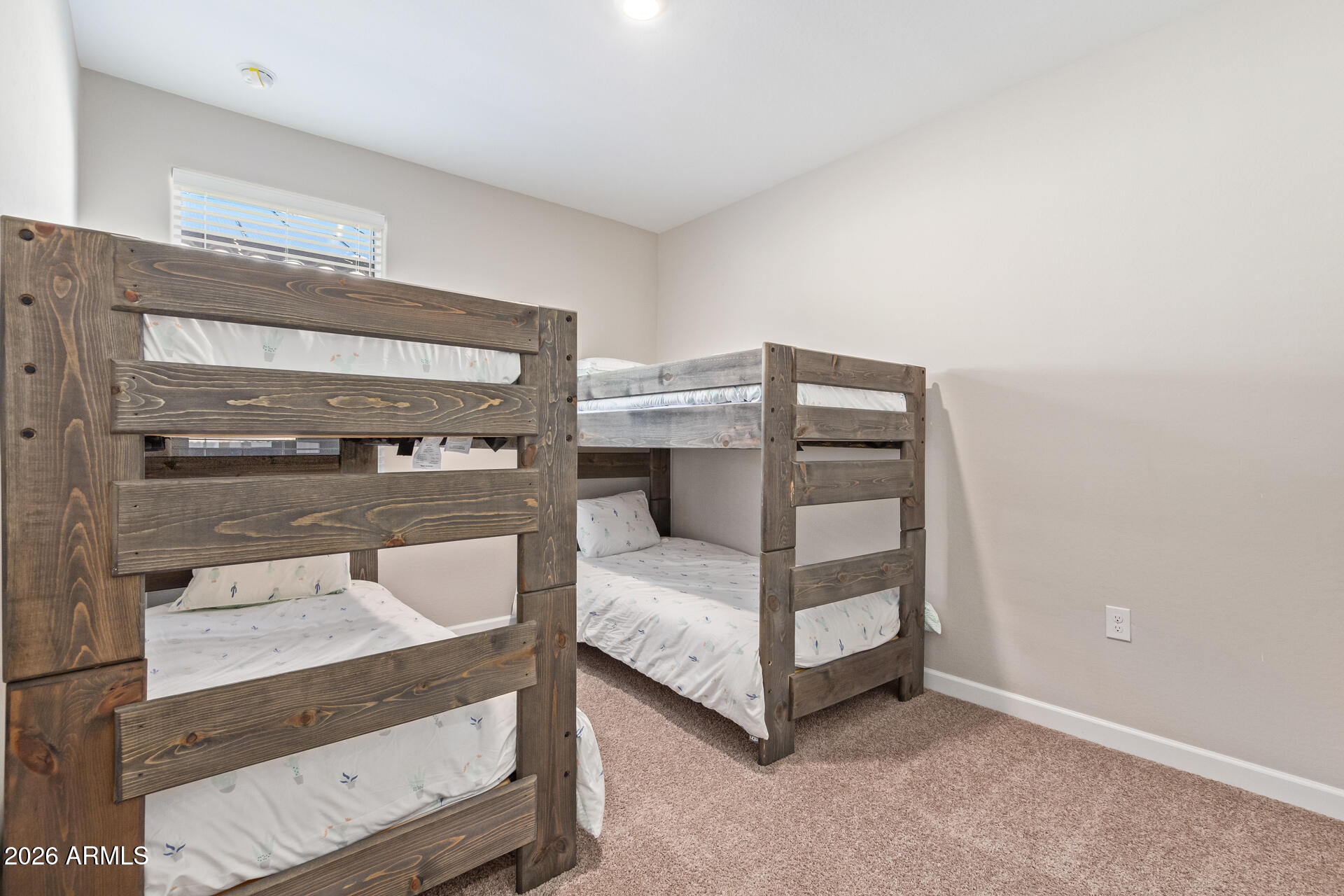 8835 South 166th Avenue Goodyear, AZ 85338 - Photo 8 of 23 a bedroom with a bed and large window