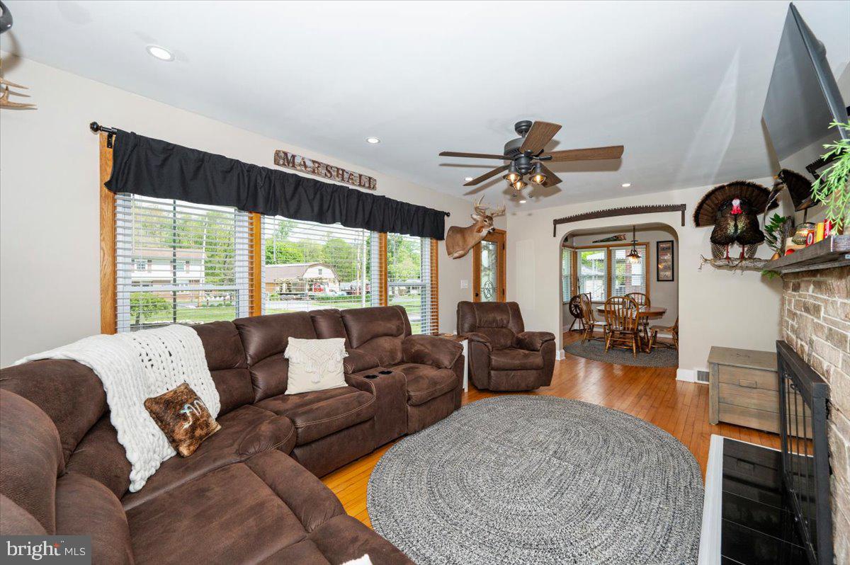7117 Blue Mountain Road Thurmont, MD 21788 - Photo 12 of 80 a living room with fireplace furniture and a flat screen tv