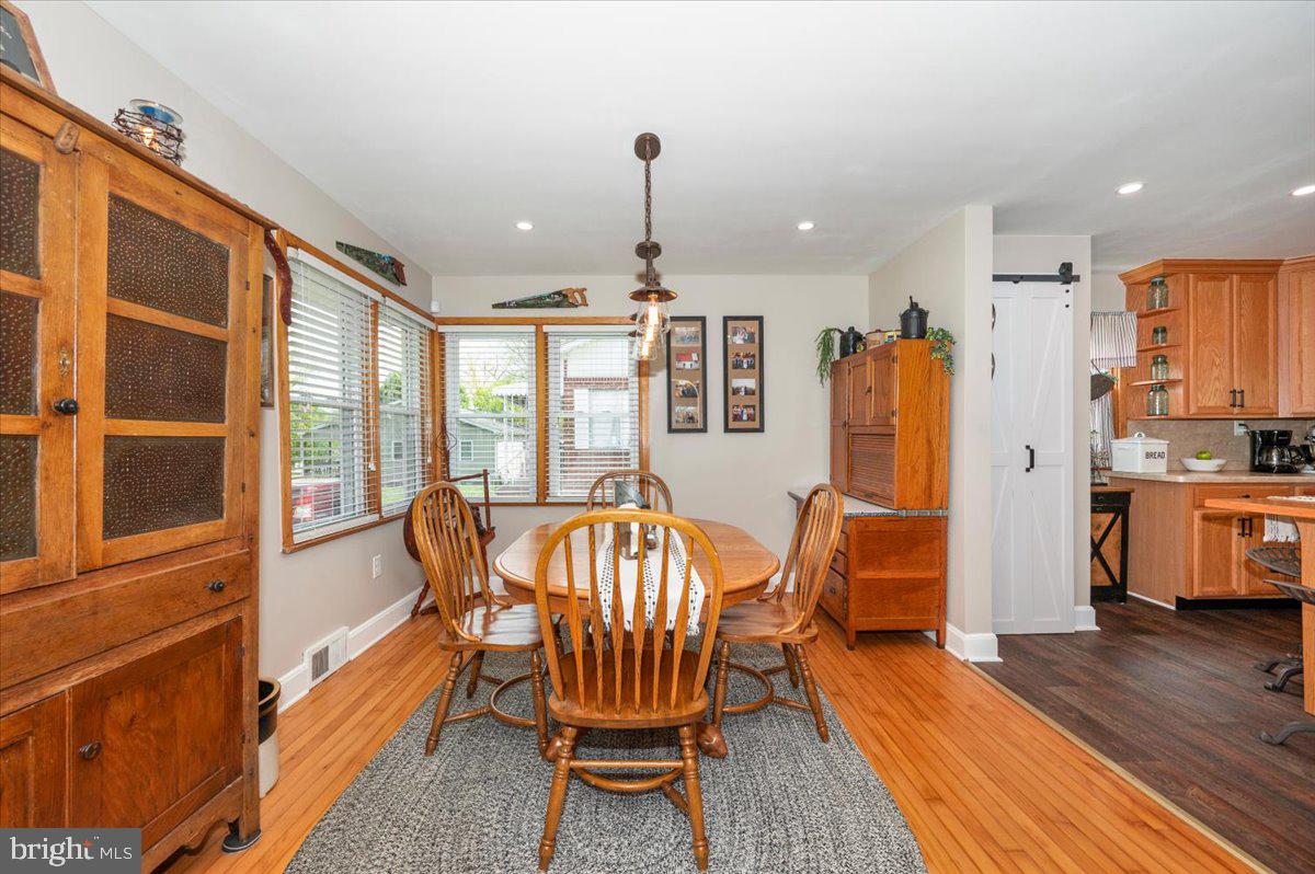 7117 Blue Mountain Road Thurmont, MD 21788 - Photo 14 of 80 a view of a dining room with furniture window and wooden floor