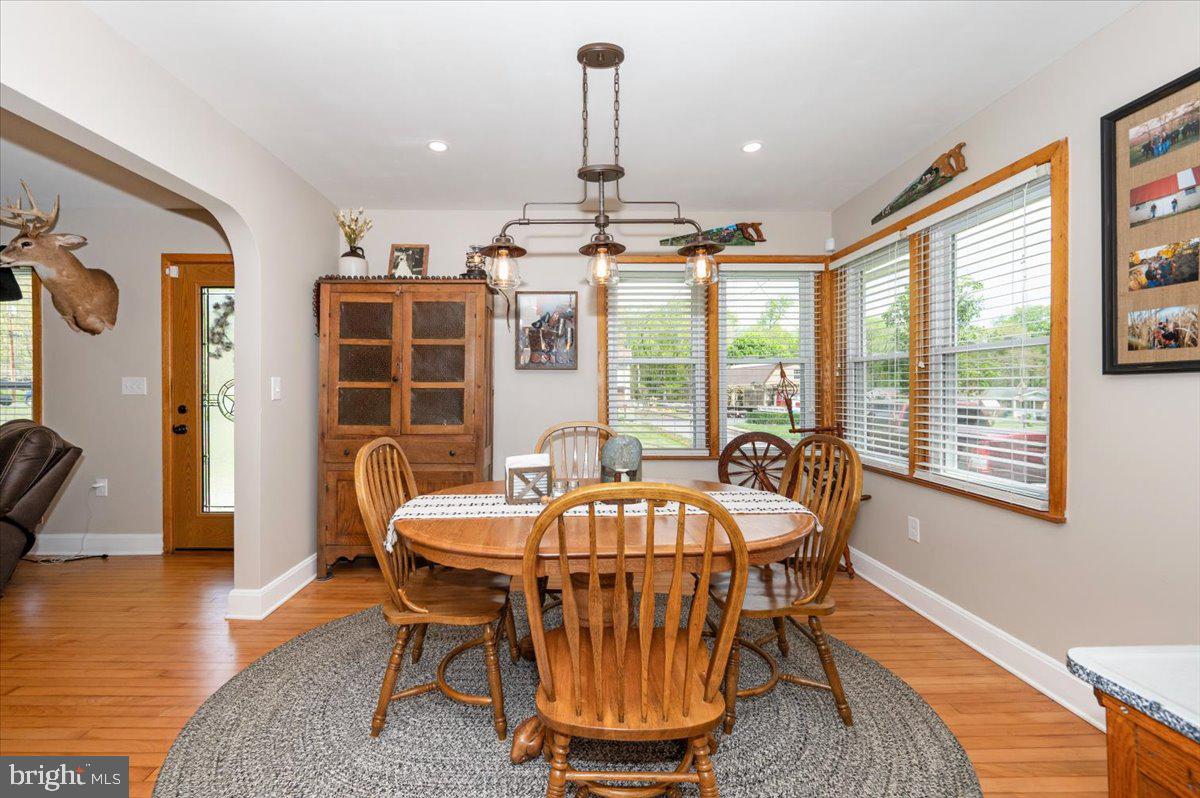 7117 Blue Mountain Road Thurmont, MD 21788 - Photo 16 of 80 a dining room with furniture a chandelier and wooden floor